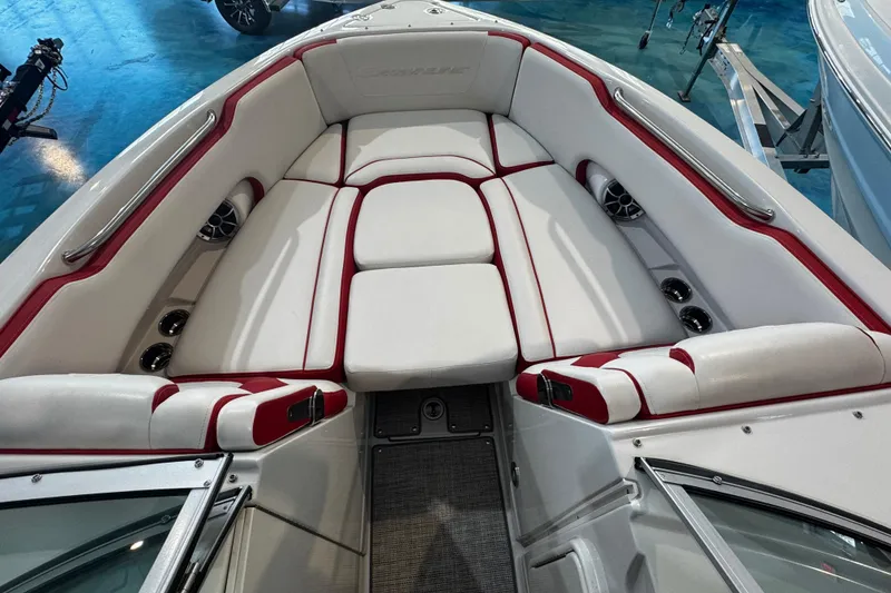 Slide: The Image of 2024 Crownline 250 XSS boat interior with white and red cushioned seating. - 6