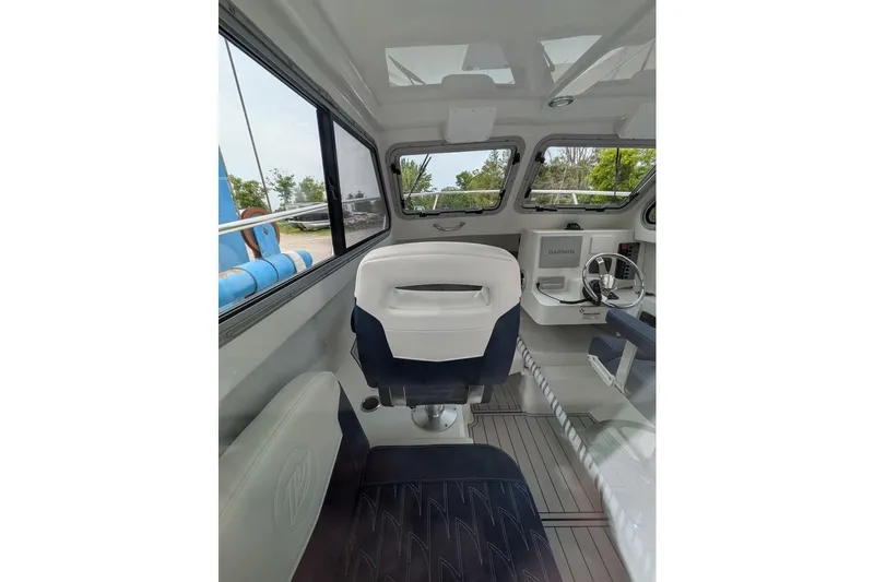 Slide: The Image of Interior of 2026 Parker 227 Explorer boat with modern seating and navigation equipment. - 11