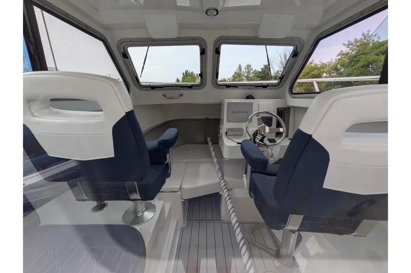 Slide: The Image of Interior of 2026 Parker 227 Explorer boat with modern seating and navigation system. - 13