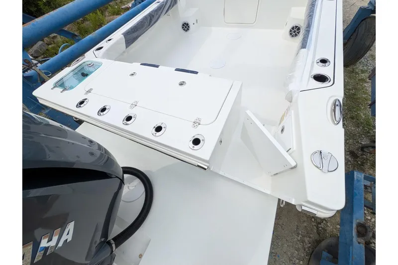 Slide: The Image of 2026 Parker 227 Explorer boat interior with Yamaha engine, featuring rod holders and storage compartments. - 8