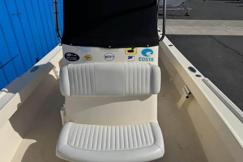 Slide: The Image of 2011 Parker 2300 Special Edition boat interior with white seating and various stickers. - 12