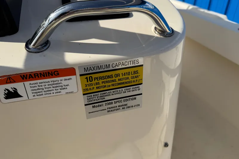 Slide: The Image of Warning label on 2011 Parker 2300 Special Edition boat, showing maximum capacities and safety instructions. - 15