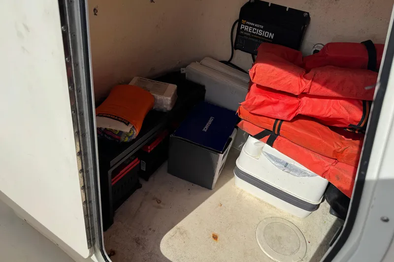 Slide: The Image of Storage compartment of a 2011 Parker 2300 Special Edition boat with life jackets and equipment. - 19