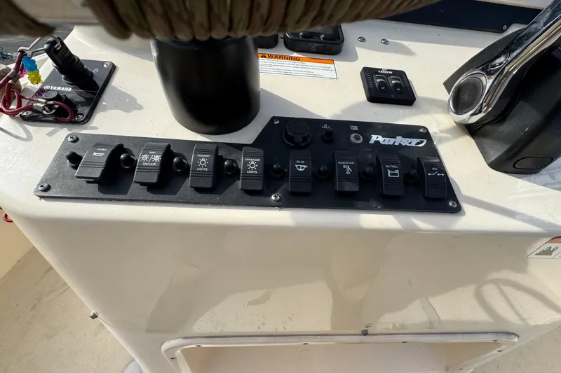 Slide: The Image of Control panel of a 2011 Parker 2300 Special Edition boat with various switches. - 23