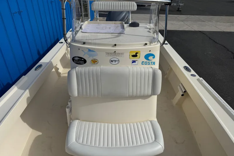 Slide: The Image of 2011 Parker 2300 Special Edition boat interior with white seating and various stickers. - 30