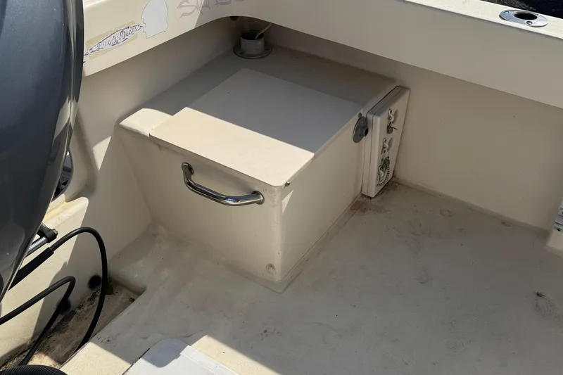 Slide: The Image of Storage compartment on a 2011 Parker 2300 Special Edition boat interior. - 7