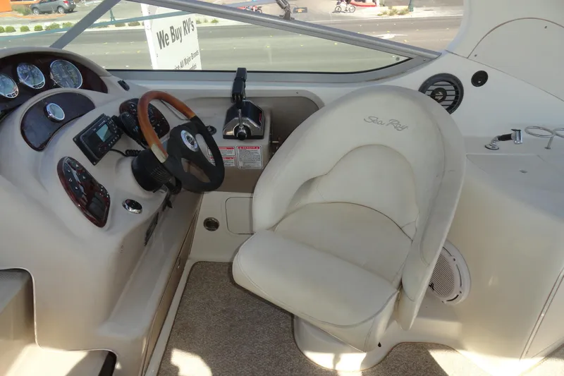 Slide: The Image of 2004 Sea Ray Sundancer 280 helm with steering wheel and control panel. - 13