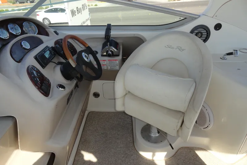 Slide: The Image of 2004 Sea Ray Sundancer 280 helm with steering wheel and control panel. - 14