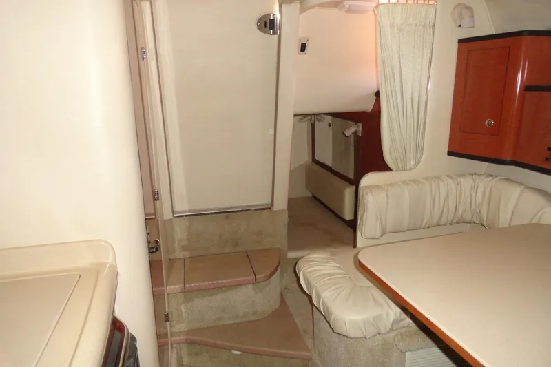 Slide: The Image of 2004 Sea Ray Sundancer 280 cabin interior with seating, table, and stairs. - 25