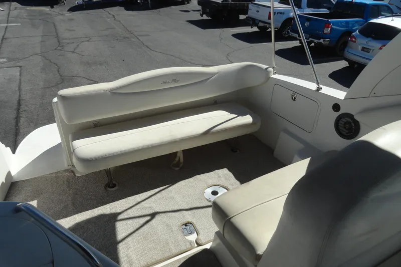 Slide: The Image of 2004 Sea Ray Sundancer 280 boat interior with white seating and carpeted floor. - 31