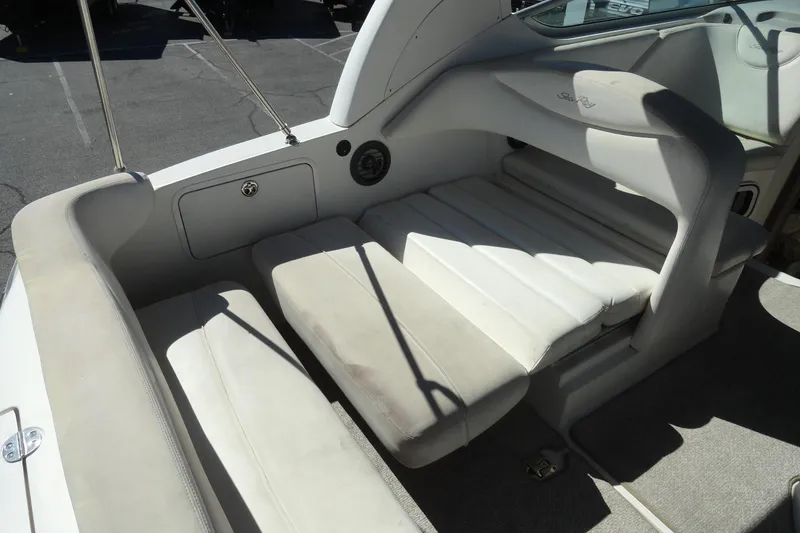 Slide: The Image of 2004 Sea Ray Sundancer 280 boat interior with white cushioned seating area. - 32