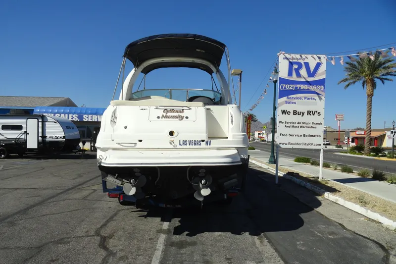 Slide: The Image of 2004 Sea Ray Sundancer 280 boat parked at RV dealership, sunny day, palm trees visible. - 37