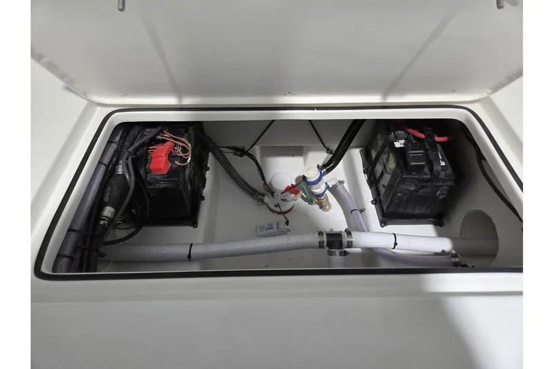 Slide: The Image of Battery compartment of 2026 Parker 247 Explorer boat, featuring wiring and plumbing. - 11