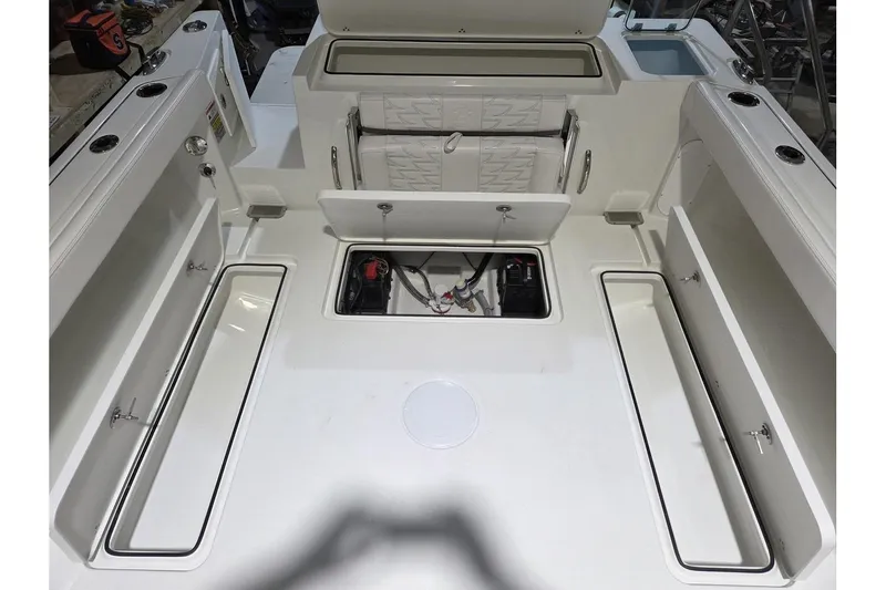 Slide: The Image of 2026 Parker 247 Explorer boat interior with open storage compartments and seating. - 12