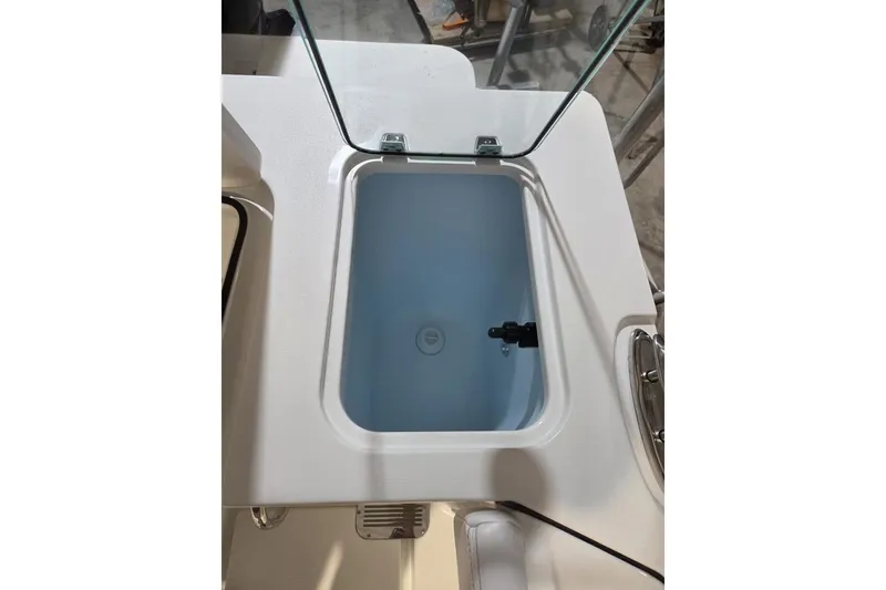 Slide: The Image of Livewell compartment on 2026 Parker 247 Explorer boat, open lid, white interior. - 14