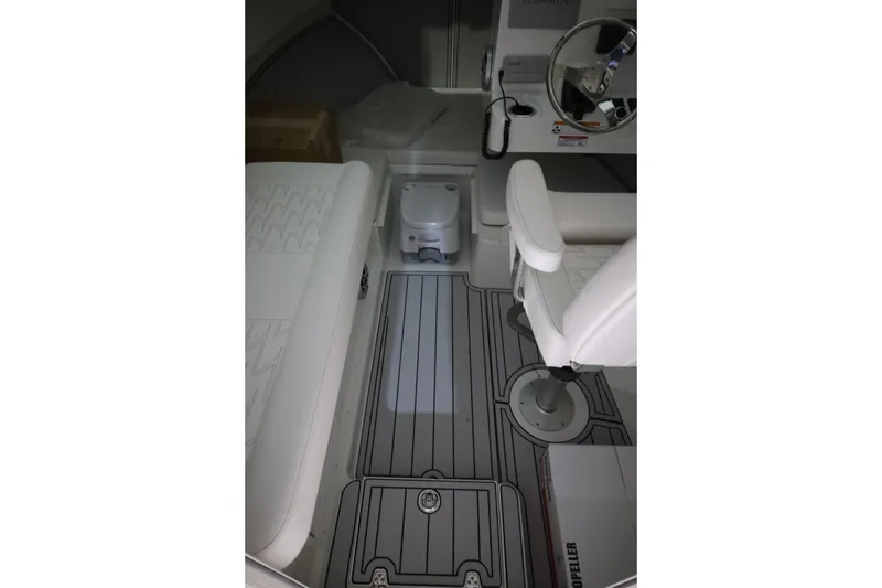 Slide: The Image of Interior of 2026 Parker 247 Explorer boat with white seating and steering wheel. - 19
