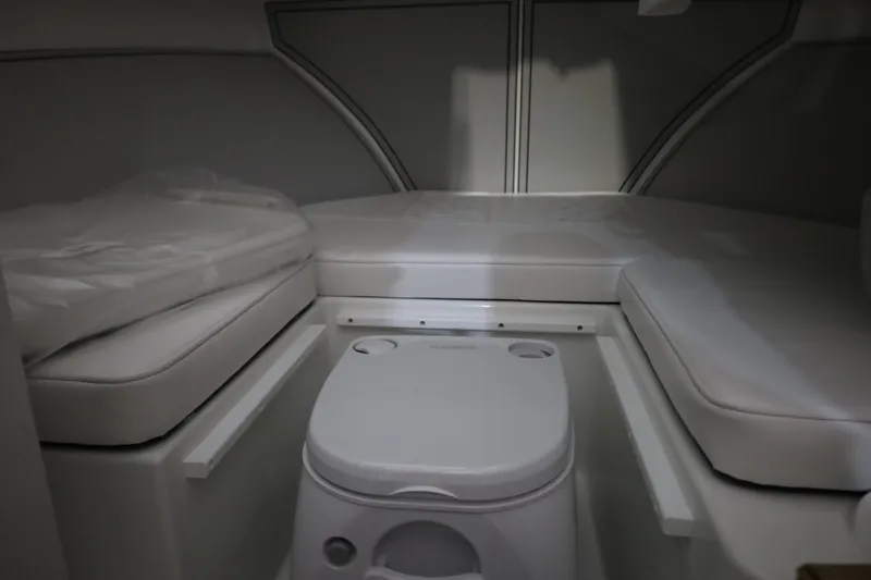 Slide: The Image of Interior cabin of 2026 Parker 247 Explorer boat with compact toilet and cushioned seating. - 20