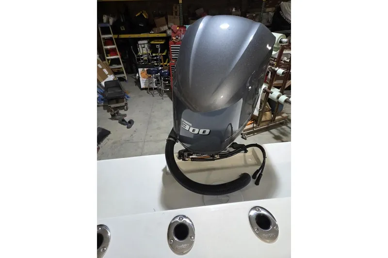 Slide: The Image of Outboard motor on a 2026 Parker 247 Explorer boat in a workshop setting. - 3
