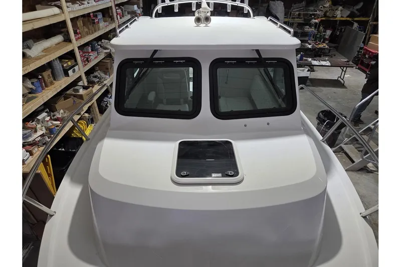 Slide: The Image of 2026 Parker 247 Explorer boat in a workshop setting, showcasing its sleek design. - 5