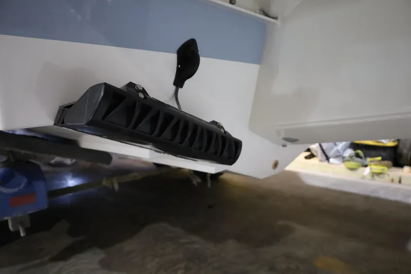 Slide: The Image of 2026 Parker 247 Explorer boat detail, showcasing hull and equipment in a garage setting. - 7