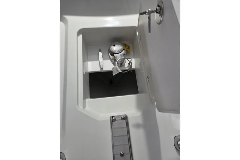 Slide: The Image of Storage compartment on a 2026 Parker 247 Explorer boat, featuring a secure latch. - 9