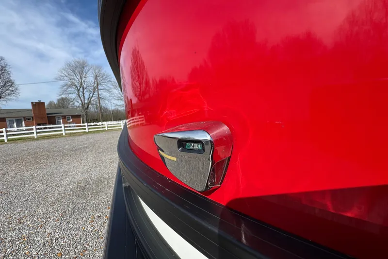 Slide: The Image of 2024 Trifecta 25ULE SS boat with vibrant red exterior and chrome detailing. - 18