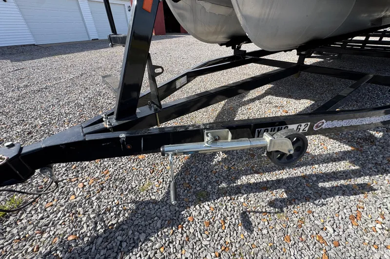 Slide: The Image of Trailer hitch of 2024 Trifecta 25ULE SS boat on gravel surface. - 26