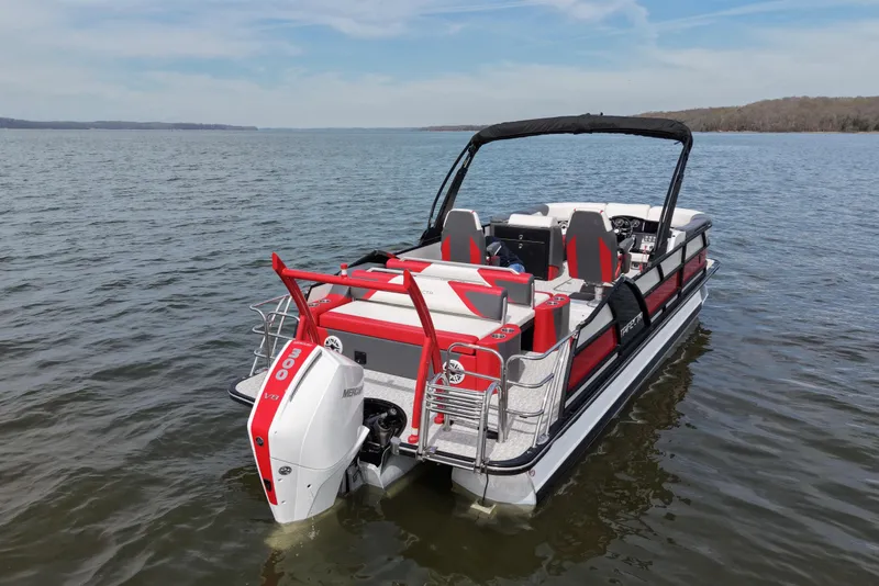 Slide: The Image of 2024 Trifecta 25ULE SS pontoon boat on a calm lake. - 3