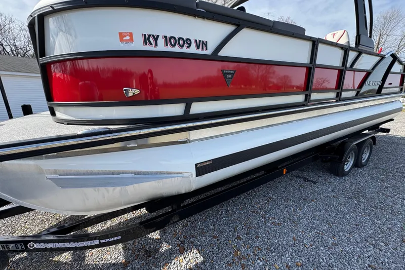 Slide: The Image of 2024 Trifecta 25ULE SS pontoon boat on trailer, side view. - 30