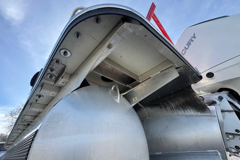 Slide: The Image of 2024 Trifecta 25ULE SS pontoon boat underside with Mercury engine, showcasing aluminum construction. - 33