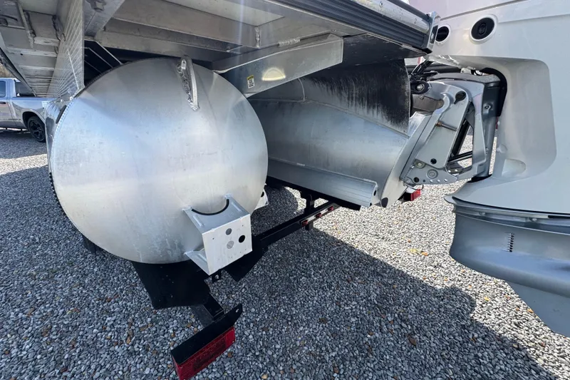 Slide: The Image of Rear view of 2024 Trifecta 25ULE SS pontoon boat on gravel surface. - 34