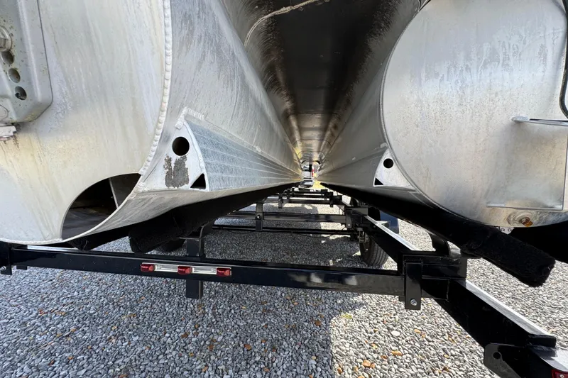 Slide: The Image of Underneath view of 2024 Trifecta 25ULE SS pontoon boat on a trailer. - 36