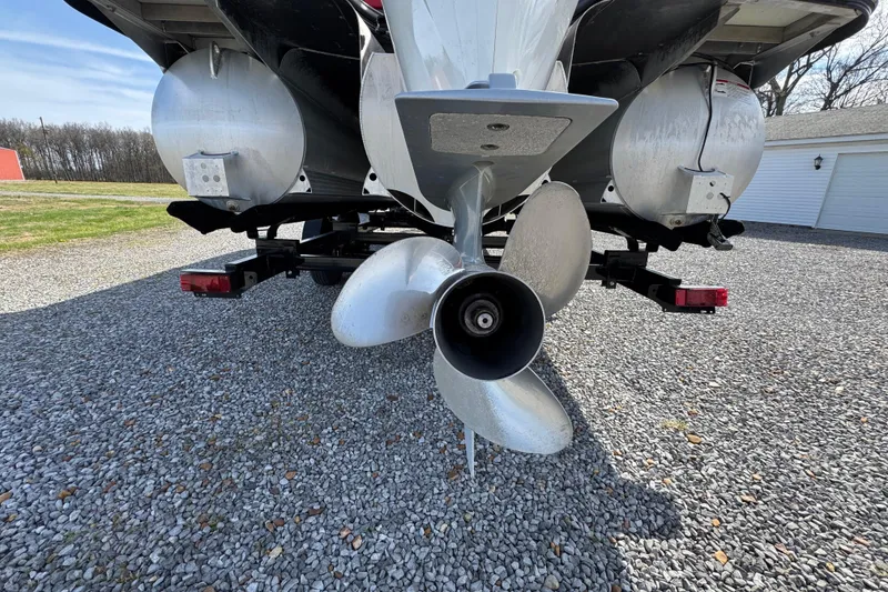 Slide: The Image of Rear view of 2024 Trifecta 25ULE SS boat propeller on gravel driveway. - 38