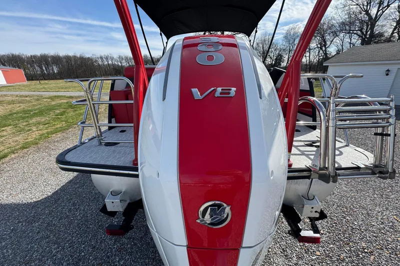 Slide: The Image of 2024 Trifecta 25ULE SS boat with V8 engine, red and white design, parked outdoors. - 39