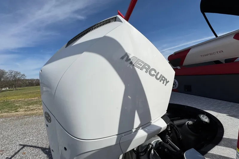 Slide: The Image of 2024 Trifecta 25ULE SS with Mercury engine, outdoor setting, clear sky. - 40