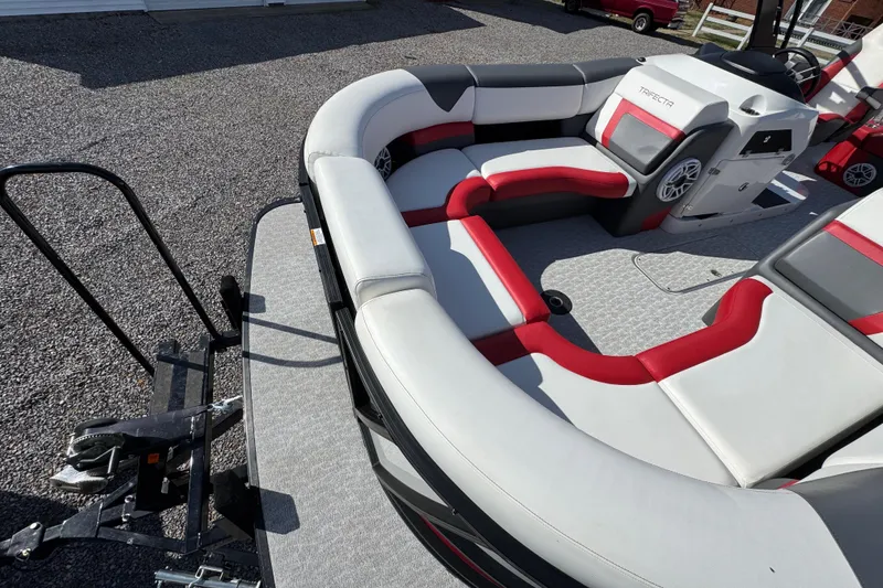 Slide: The Image of 2024 Trifecta 25ULE SS pontoon boat with stylish red and gray seating. - 51