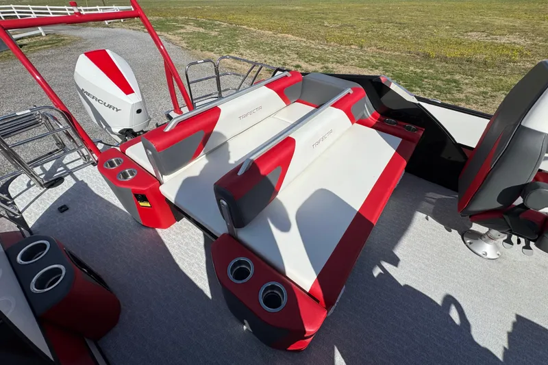 Slide: The Image of 2024 Trifecta 25ULE SS boat interior with red and white seating and Mercury engine. - 57