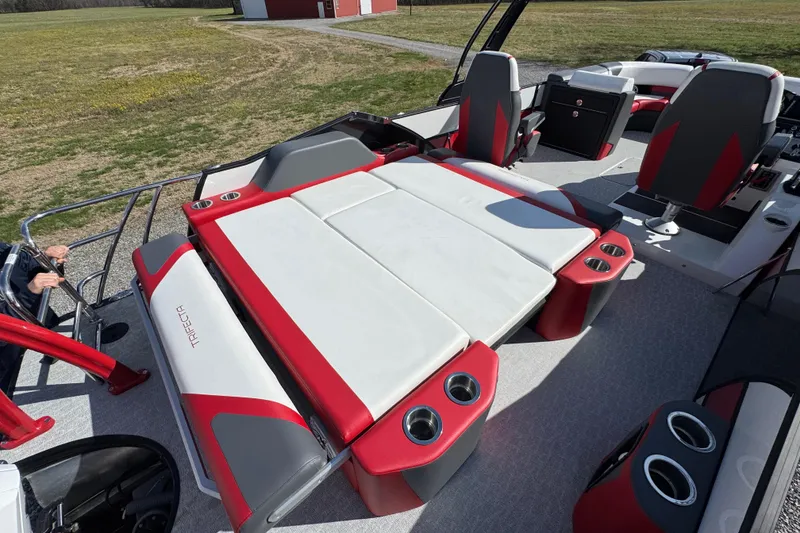 Slide: The Image of 2024 Trifecta 25ULE SS boat interior with red and white seating and cup holders. - 61