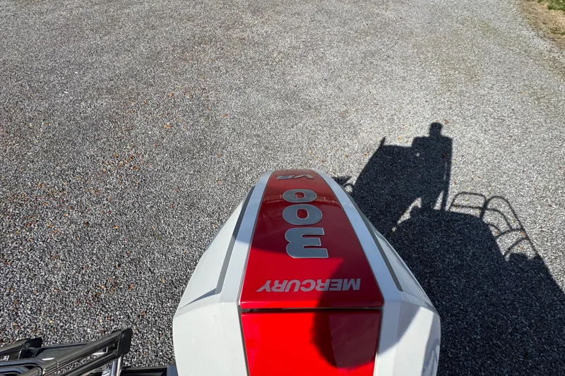 Slide: The Image of 2024 Trifecta 25ULE SS with Mercury 300 engine on gravel surface. - 64