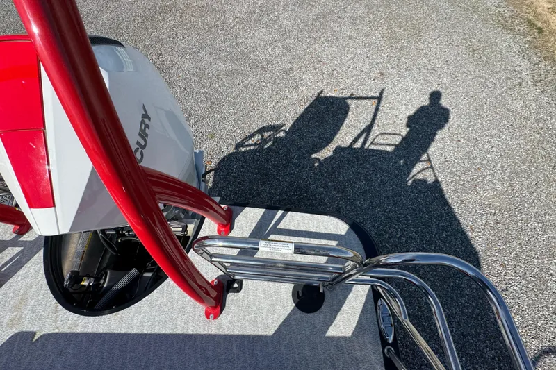 Slide: The Image of 2024 Trifecta 25ULE SS boat with Mercury engine, shadow on gravel. - 67