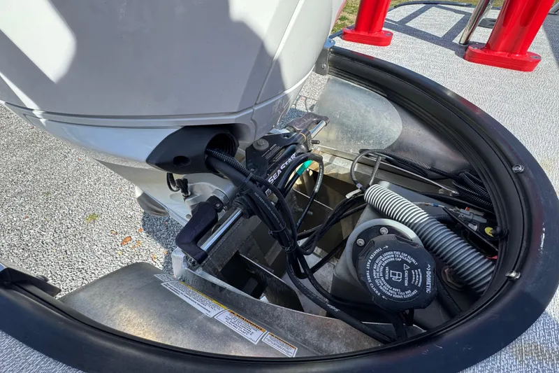 Slide: The Image of 2024 Trifecta 25ULE SS boat engine compartment with visible wiring and components. - 70