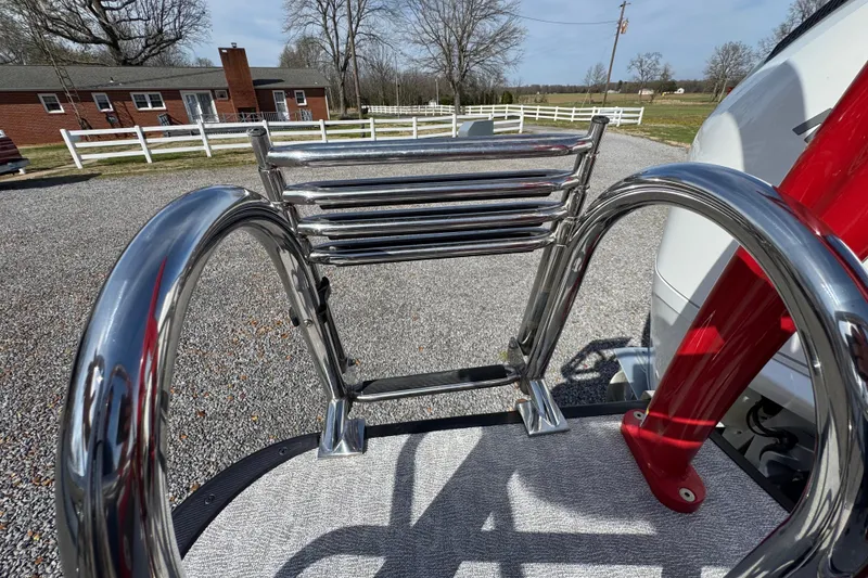 Slide: The Image of 2024 Trifecta 25ULE SS boat ladder with chrome finish in a rural setting. - 71