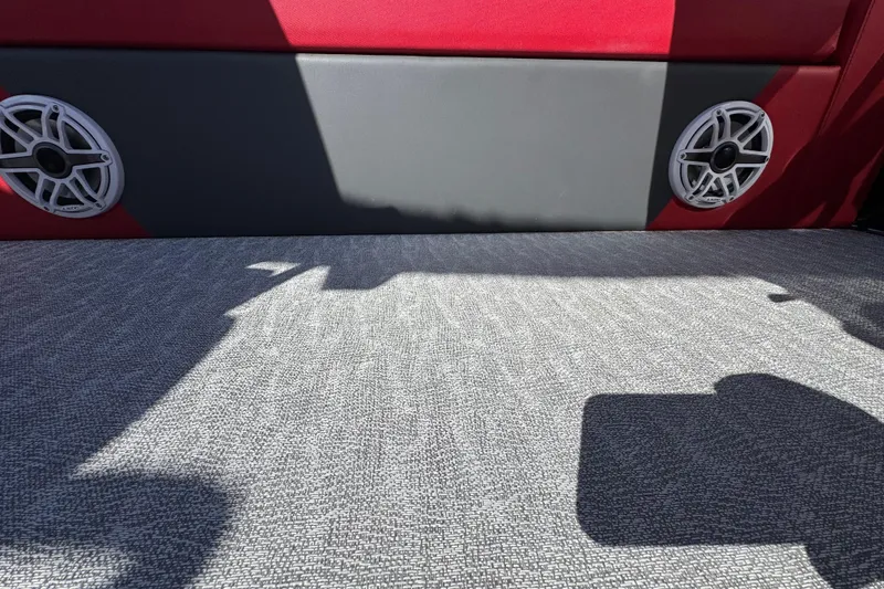 Slide: The Image of 2024 Trifecta 25ULE SS interior with red and gray upholstery, featuring dual speakers. - 73