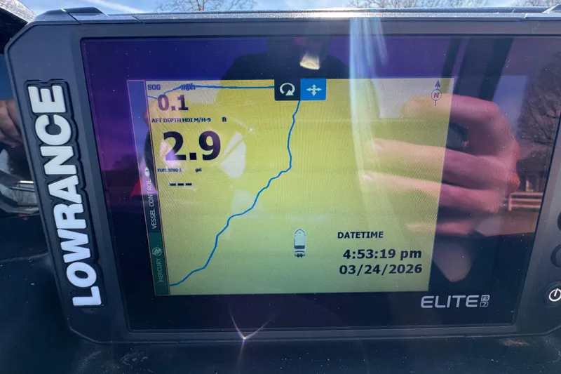 Slide: The Image of Lowrance Elite FS7 display on Trifecta 25ULE SS, showing navigation data and date. - 80