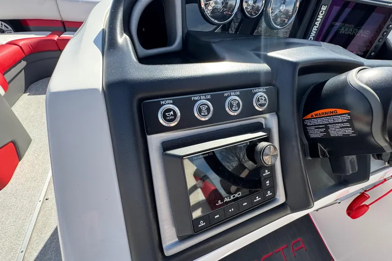 Slide: The Image of 2024 Trifecta 25ULE SS boat dashboard with JL Audio system and control panel. - 82