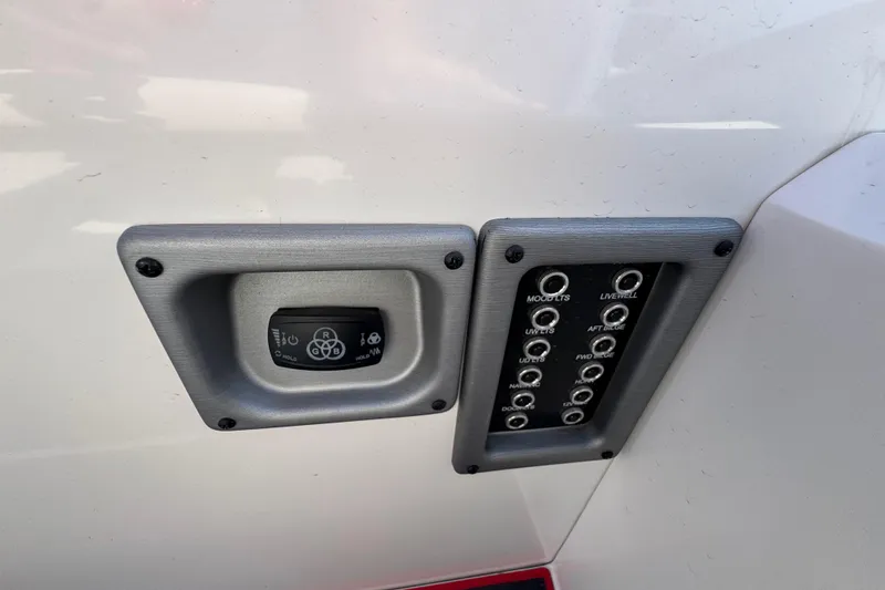 Slide: The Image of Control panel on 2024 Trifecta 25ULE SS boat, featuring switches and buttons. - 84