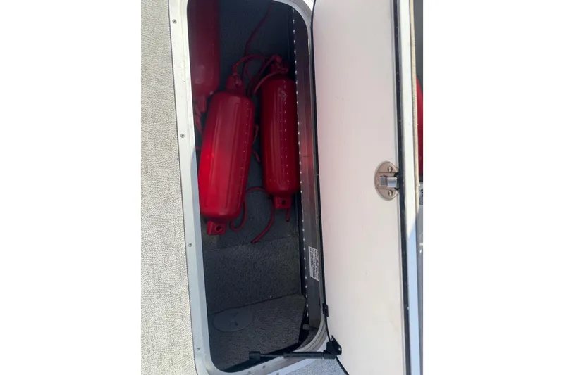 Slide: The Image of Storage compartment with red fenders in 2024 Trifecta 25ULE SS boat. - 90