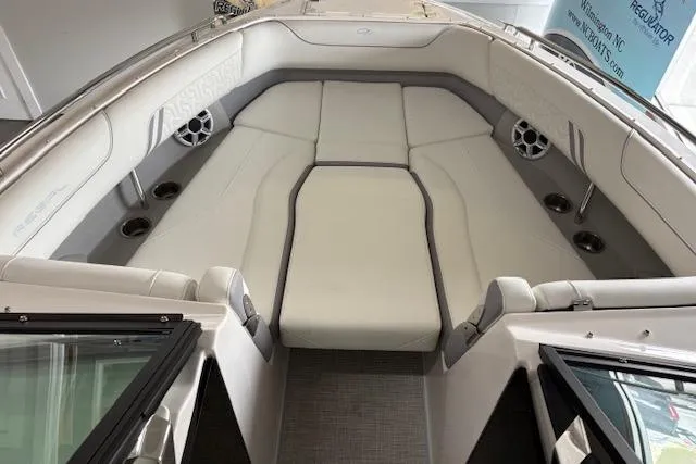 Slide: The Image of 2026 Regal LX6 boat interior with white seating and cup holders. - 13