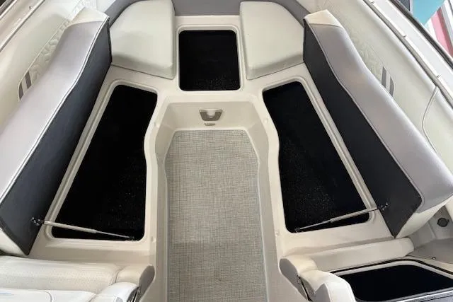 Slide: The Image of 2026 Regal LX6 boat interior with cushioned seating and storage compartments. - 14