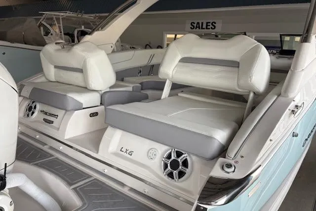 Slide: The Image of 2026 Regal LX6 boat interior with white and gray seating, displayed at a sales showroom. - 3